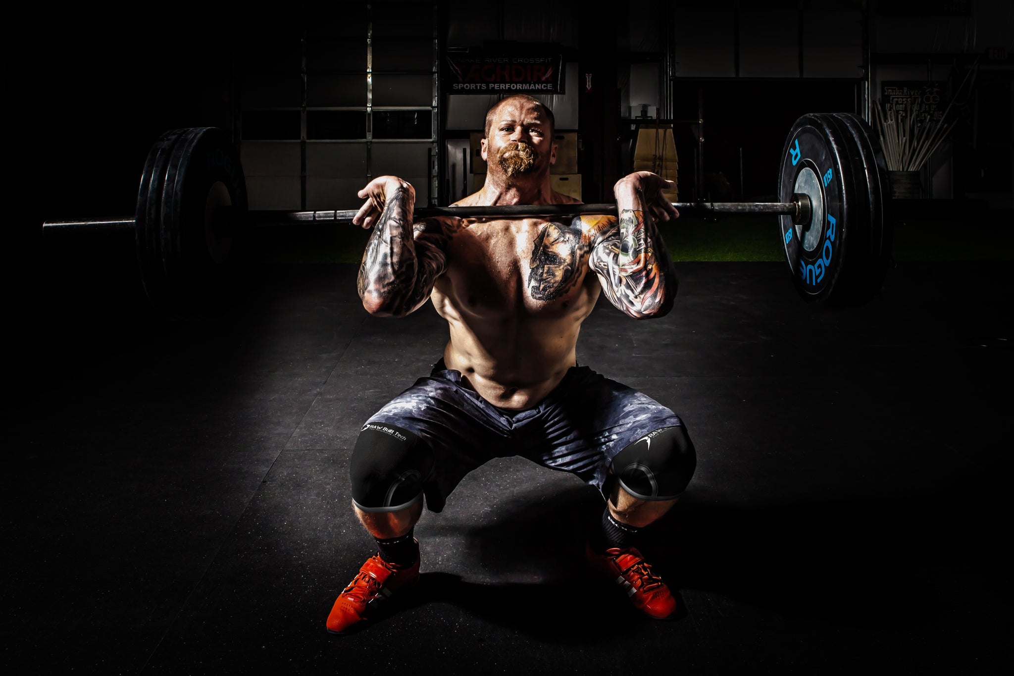 Strong man squat with knee sleeve protection