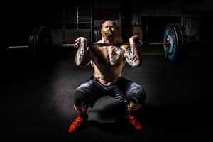 Strong man squat with knee sleeve protection